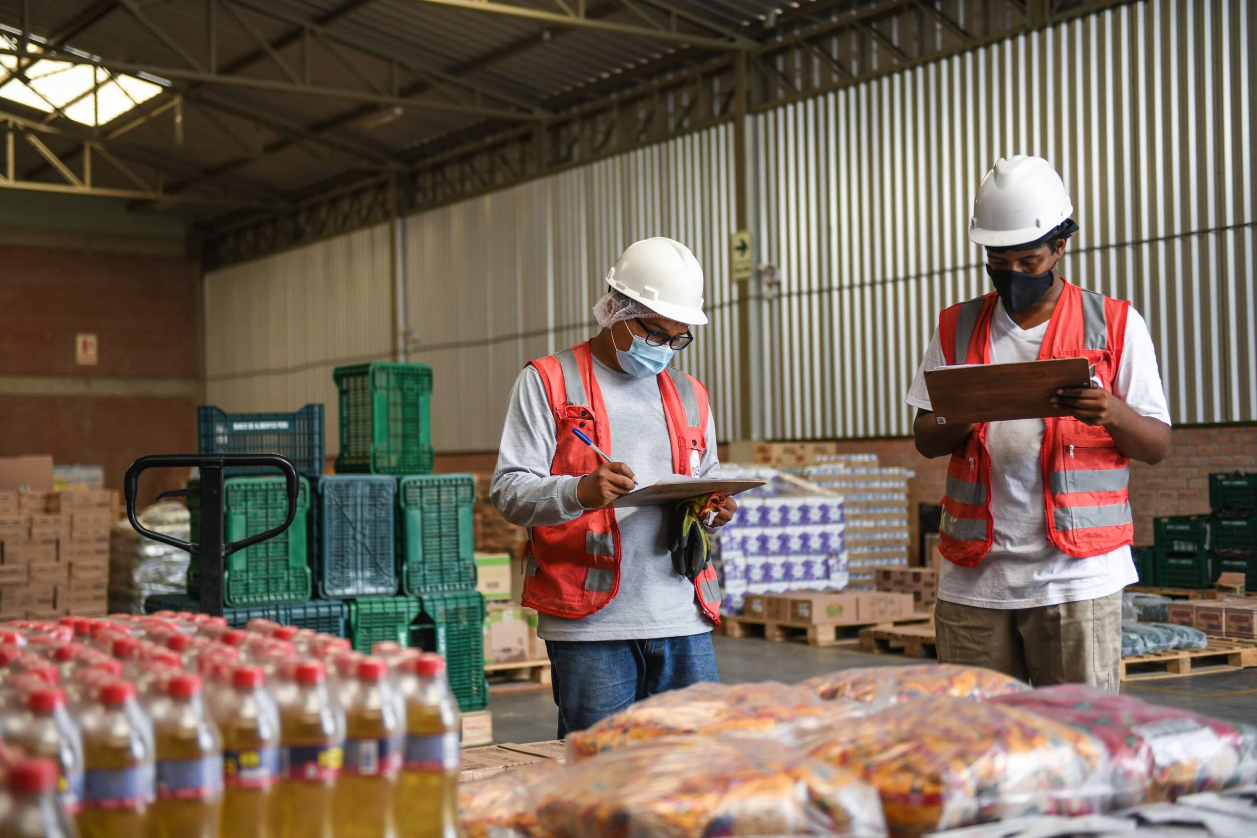 Staff from Banco de Alimentos Perú (BAP) review the inventory of food in the warehouse.